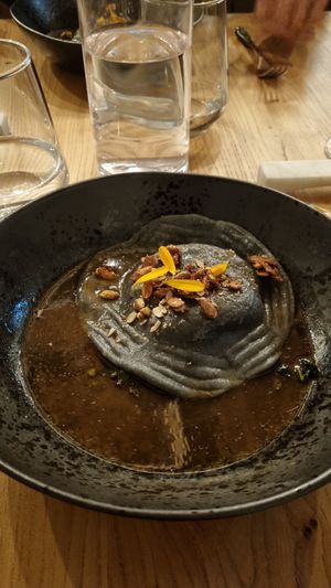 Raviolo met miso-pompoen en in koffie geroosterde knolselderijbouillon at Kasvio in Utrecht