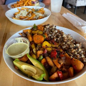Protein bowl with truffle fries and Impossible  Burger in the background  at Earth Cafe in Myrtle Beach
