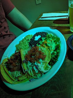 Tofu tacos with black beans, a side salad and rice. We had to scrape off the crema on the black beans but we'll order without it next time. at Bit & Spur in Springdale