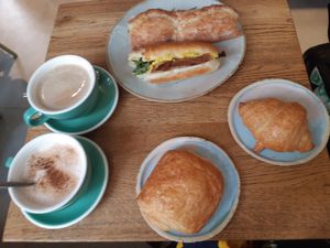 Bacon sandwich, mediteran sandwich, croissant, pain au chocolate, cappucino & chai at Land & Monkeys - Pernety in Paris