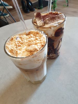 Cheesecake Latte with biscuit crumbles any Tiramisu Latte with chocolate syrup (both vegan and delicious!) at Coffea in Berlin