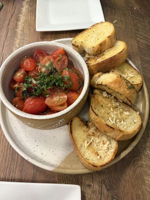 Garlic bread and tomatoes YUM  at PiANTA in Providence