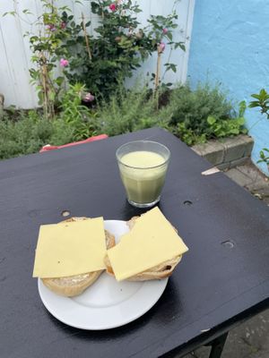 Sourdough bun with vegan butter and cheese and a matcha latte with oat milk   at Brødre Bageri in Tejn