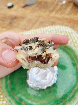 Small tart made of almond, chocolate inside, almond and pumpkinseeds on top. at Tant Grön in Vintrosa