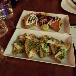 Chipotle Quesadilla on top, onion and pear pizza on bottom at Living Kitchen - South End in Charlotte