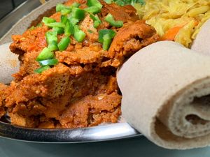 Yetsom Ferfer: Vegan Spicy Stew made of Tomatoes, Berbere Sauce, Jalapeños, and pieces of Injera at Gojo Ethiopian Cuisine in Grand Rapids
