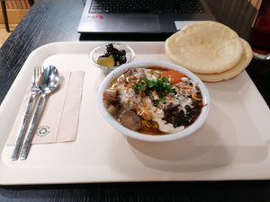 Hummus meal with mushrooms, pitta, olives, black beans.  at Coworking Lounge Tessinerplatz - Coffee Shop in Zurich
