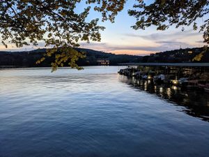 Two levels of outdoor tables lakeside. at Mozart's Coffee Roasters in Austin