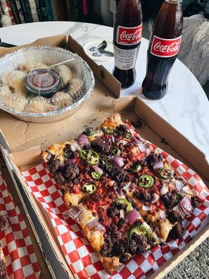 Vegan pizza (vegan cheese and sausage) with vegan knots! So good!  at Guerrilla Pizza  in Las Vegas