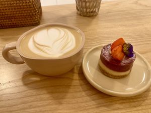 Hot latte and tangy lemon raspberry mini cake  at Rawberry in Ho Chi Minh City