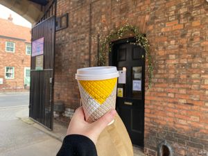 Latte and vegan brownies in brown paper bag at The Coffee Club in Selby