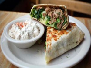 chiggen caesar wrap: soy chicken strips, romaine, tomato and onion with Caesar dressing. with a side of cottage cheez at Highline Bar in Seattle