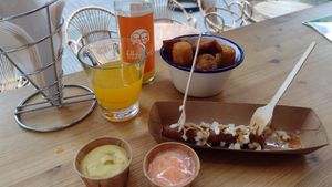 Frikandel (already took one bite!) & 12 piece snack platter (bitterballen, spicy egg rolls & deep fried cheese) at Last Vegas in Utrecht