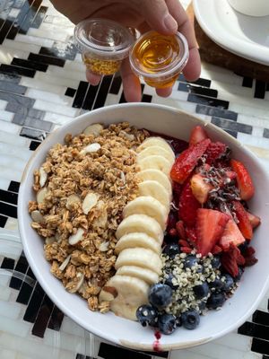 Açaí bowl with bee pollen and honey on the side. at Rooted Coffeehouse in Evans
