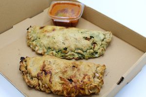 Made with Gluten-Free pizza dough. Your choice of protein, sauce, and cheese at Plant Base Cafe in Santa Fe