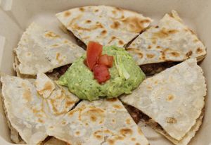 Quesadilla Your choice of protein & cheese, between two GF flour tortillas. Served with a scoop of guacamole and your choice of hot sauce. at Plant Base Cafe in Santa Fe