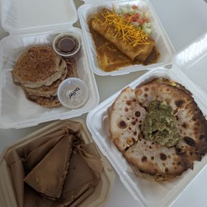 Pancakes, breakfast burrito, breakfast quesadilla, salted caramel cheesecake.  at Plant Base Cafe in Santa Fe