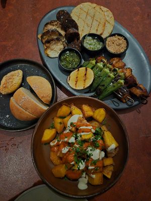 Parrillada 56: overpriced!! didn't enjoy the chikn, lions mane, or chorizo texture, okra, chimichurri, + pico de gallo was nice; Potato bread+butter 12 + Patatas bravas 18: delish at Lona Misa in South Yarra
