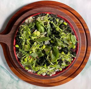 LIVIN” on the Green Pizza

Kale Pesto, Broccoli, Cheese, Leaves, Edamame, Chili flakes & Toasted Pepitas. at Just Vegan - Jumeriah in Dubai