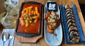 Homemade ginger lemonade, tteokbokki,  fried cauliflower wings with pickled radish, and bulbossot kimbap 😍  at Kini in Hamburg