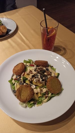 Salad with chickpea polpeti, avocado, nuts, cherry tomatos and dressing. at Sputnik in Ljubljana