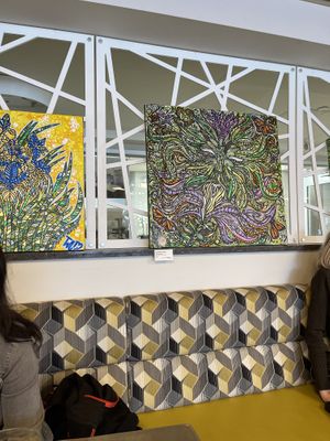 Paintings on sale on the wall  at Good Eats Cafe in Ottawa
