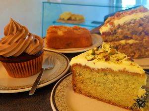 A selection of the cakes we offer, which are always changing. Pictured here (from far left clockwise): Jaffa cupcake, cherry bakewell slice, carrot cake, and courgette & lime cake. at Bumbles' Rest Cafe in Ambleside