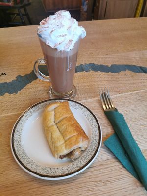 Hot chocolate with vegan cream and vegan sausage roll at Bumbles' Rest Cafe in Ambleside