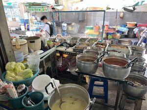 Food stall/kitchen with seating behind   at Nang Aharn Jay in Bangkok