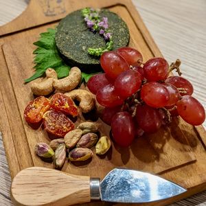Fermented Spirulina Vegan Nut Cheese Platter with Dried Cherry Tomatoes, Organic Nuts, and Grapes at WakaMama in Central Singapore