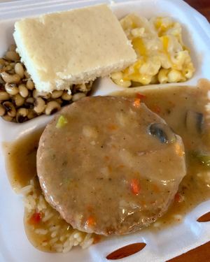 Salisbury steak over rice with black eyed peas and mac and cheese  at Hungry Vegan in Savannah