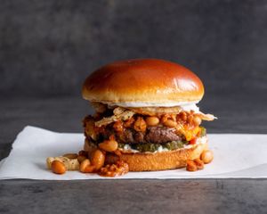Chili-Cheese - Grilled Impossible patty with chili, cheddar, pickles, crispy onion strings, and ranch on a brioche bun at Stand-Up Burgers - Wells in Chicago