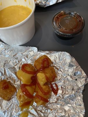 Tots and cheese sauce  at Stand-Up Burgers - Wells in Chicago