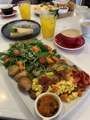 Vegan brunch, cappuccino with oat milk, fresh orange juice and passion fruit cheese cake at Manifest Lisbon in Lisbon