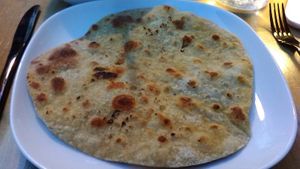 Chapati, a grilled, whole-wheat, unleavened bread from Cinnamon, served June 2021. That evening, the restaurant was out of quinoa, the reviewer's first choice for a starch. at Cinnamon in Rhinebeck