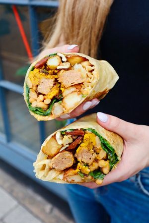 Our Big Breakfast Burrito. 
B*con, s*usage, fried potatoes, mushrooms,
cheese, hash brown, spinach, baked beans
+ scrambled curried tofu served in a wrap at Slice + Dice in Norwich