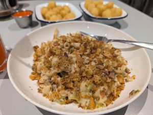 Mac and cheese and tator tots in background at Slice + Dice in Norwich