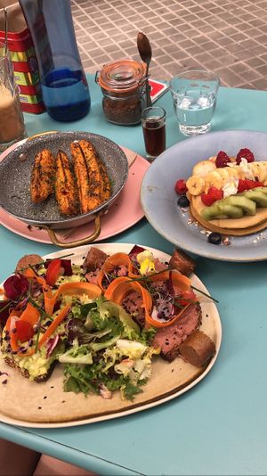 Sweet potatoes, avocado/beet toast, and pancakes with fruit  at Faire Brunch & Drinks in Barcelona