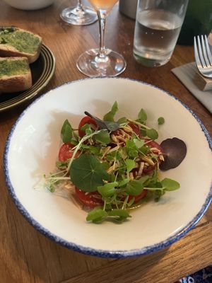 Tomato salad with oils nuts and herbs  at Bistro Lupa in Copenhagen