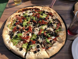 Veggie pizza (vegan) with Daiya cheeze and whole wheat crust. Seriously under cooked. By the obsession with raw vegetables on a pizza?? I substituted sun dried tomatoes for raw.   at Woodstock's Pizza in Davis