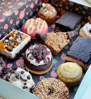 Best of box with 12 different pieces: Black forest donut, carrot cake cupcake, vegan peanut chocolate caramel bite, oreo cookie etc. at Kjeks - Schanze in Hamburg