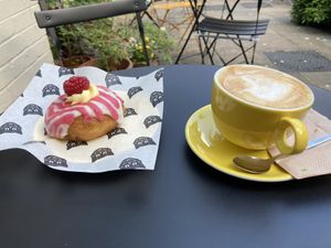 Raspberry donut and oat milk latte.  at Dee Dees Vegan Cafe in Biggleswade