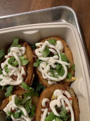 Crispy potato skins with bacon bits and sour cream  at DC Vegan in Washington