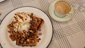 Belgian waffles topped with whipped cream, hazelnuts, and apple compote with a cafe breve. Delicious! at Acorn Community Cafe in Eugene