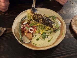Charred cabbage with sauce, tomato, and green onionn  at Fat Veggies in Barcelona
