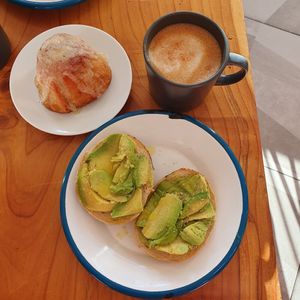 Avocado poppy seed bagel, cinnamon roll and mushroom latte at Fox and Lion Bread in San Francisco