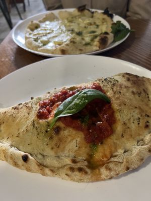 Vegan Calzone (four cheese pizza in the back)   at Intz48 Coffee Roasters Azores in Sao Miguel