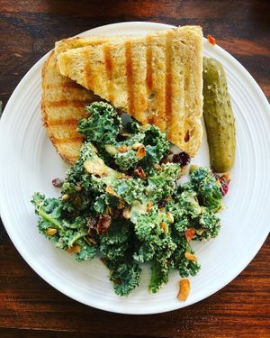Pizza pesto panini and some kale salad   at Mondays Plant Café in Calgary