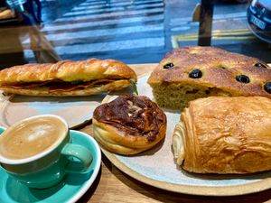 Sandwich, babka bun, olive focaccia, and chocolate croissant at Land & Monkeys - Roquette in Paris