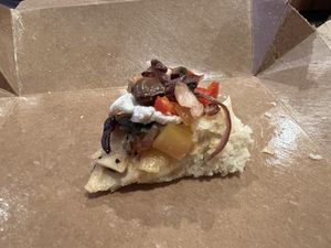 Last bite of veggie flatbread with vegan cream cheese added    at Stimulus Coffee + Bakery in Pacific City